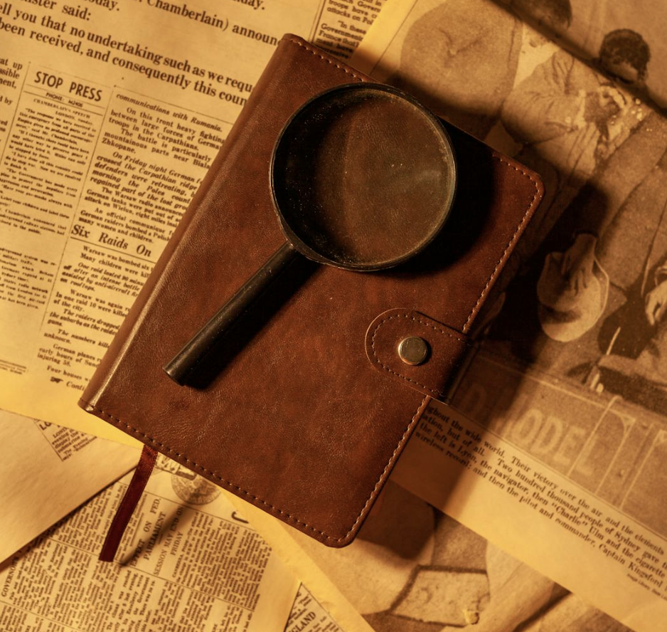 magnifying glass on leather journal